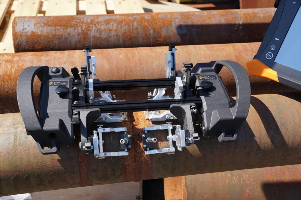 Primer plano de un equipo de ensayo de tuberías de alta tecnología, meticulosamente diseñado para la inspección y evaluación de infraestructuras críticas en entornos industriales.